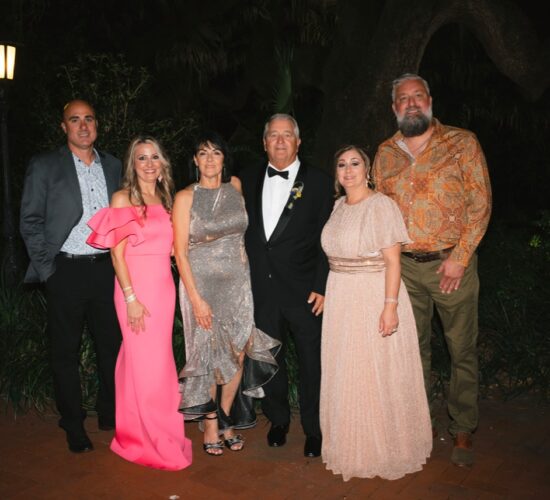 Heath Ledet posing with family and friends at a formal event