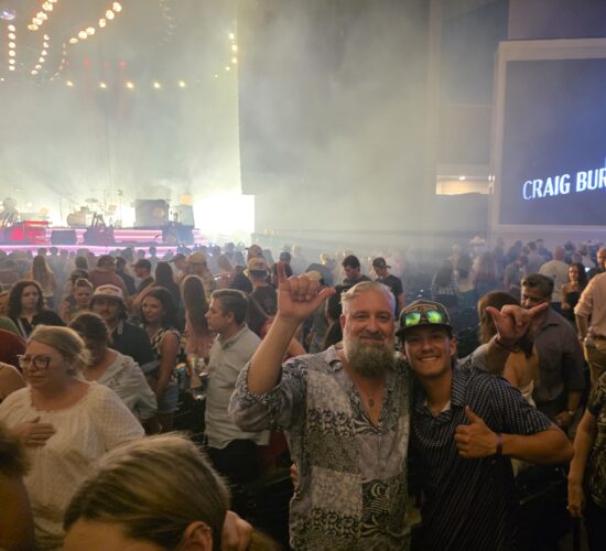Heath Ledet attending a crowded live music concert with another person.