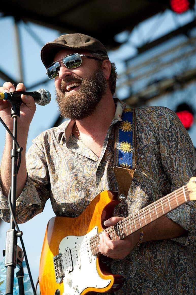 Heath Ledet performing live with an electric guitar and microphone