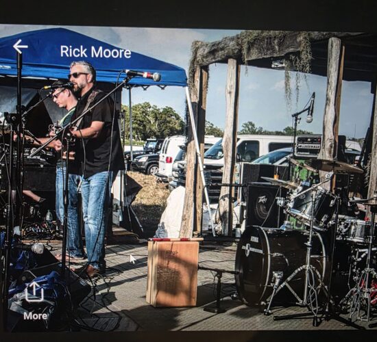 Heath Ledet is pictured at a large indoor concert with another attendee, reflecting his connection to live music, performances, and music events.