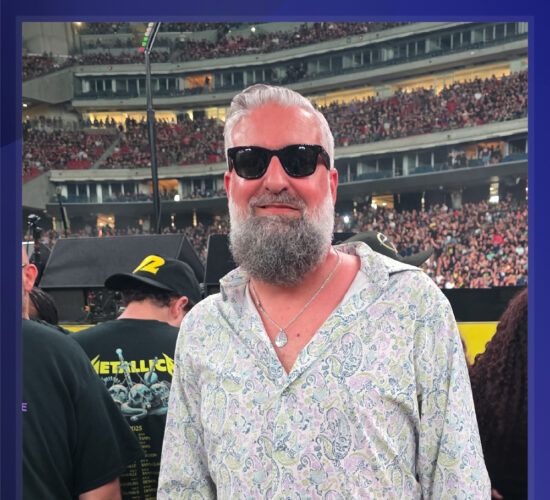 Heath Ledet attending a large live music concert in a crowded stadium.