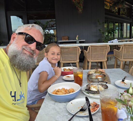 Heath Ledet enjoying an outdoor meal with family at a restaurant.