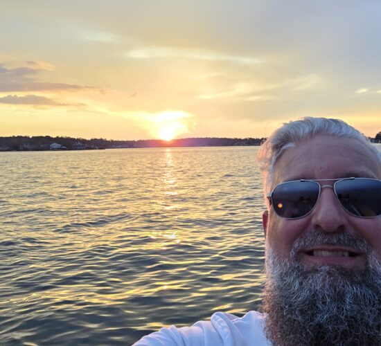 Heath Ledet enjoying a sunset boat ride on the water.