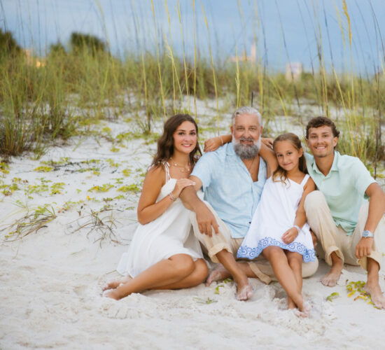 Heath Ledet posing with family on a sandy beach